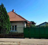 A family house on Murgašova Street in Šaľa with a red roof and a green gate.