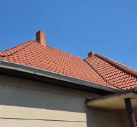 A family house on Murgašova Street in Šaľa with a tile roof and a chimney.