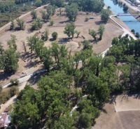 Aerial view of Recreational plots in Piešťany with wooded areas and a river.