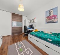 Children's room with a bed, desk, and floor with wooden decor in a 2-room apartment.