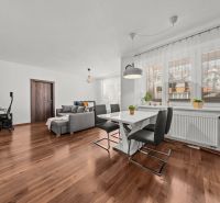 2-room apartment with wood-patterned flooring, dining area, and living section.