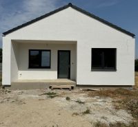 A family house in Suchá nad Parnou with a sloping roof and a light facade.