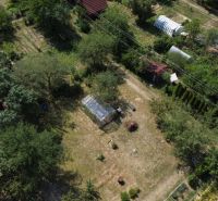 Aerial view of gardens in Detva with plenty of greenery and greenhouses.
