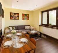 Living room in a family house with a dining table and wooden decor flooring.