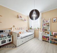Children's room with creative decorations and furniture on a floor with wooden decor.