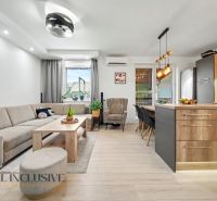 Living room with a kitchenette in a 3-room apartment, floor with wooden decor.