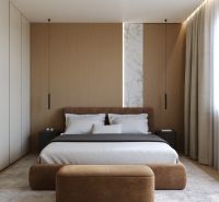 A bedroom with wood-patterned flooring, a large bed, and a decorative marble panel.