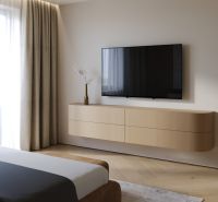 Bedroom in a 3-room apartment with a TV and a floor with a wood decor.