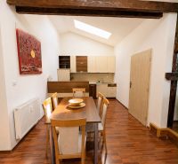 Interior of a 3-room apartment with a dining table, meadow light, and a floor with a wooden decor.