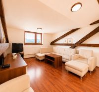 Living room in a 3-room apartment with a wooden decor floor, bright interior.