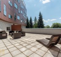 Terrace of the Recreational Apartment in Poprad with comfortable rattan furniture and a view of nature.