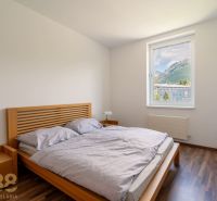 Bedroom in a holiday apartment with a view and a wooden decor floor.