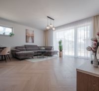 Living room in a family house with a wooden decor floor and a large sofa.