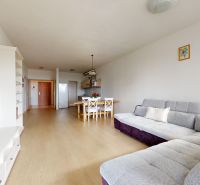 Living room with a corner sofa and a wooden decor floor in a 2-room apartment.