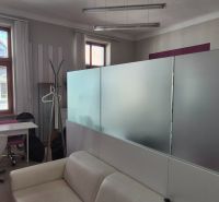 Offices with furniture, glass partitions, and flooring with a wood decor.