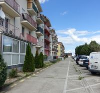 Row houses and parked cars on Agátová Street in Miloslavov next to 2-bedroom apartments.