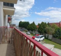 The balcony of a 2-room apartment on Agátová Street in Miloslavov with a view of the parking lot and greenery.