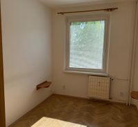A room in a 3-room apartment with a wooden decor floor and a pendant lamp.