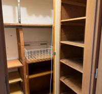 Storage space with shelves and a wire basket in a 3-room apartment.