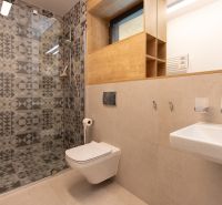 Bathroom with a shower in a 4-room apartment, decorative tiles and sanitary ware.