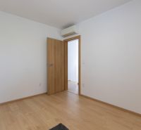 A room in a 4-room apartment with a wooden decor floor and air conditioning.