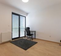 A workspace with a desk and chair in a 4-room apartment, flooring with a wood decor.