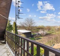 View from the balcony of a family house in Maňa on Legionárska Street, rural landscape.
