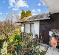 A family house on Legionárska Street in Mani with wood and garden tools.
