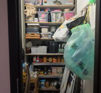 An organized pantry with supplies and storage boxes in a 3-room apartment.