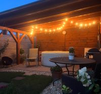 A cozy terrace of a family house in Šahy on Tešmak with lighting and a relaxation corner.