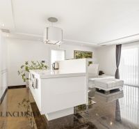 A kitchen in a family house with a shiny floor and a large window.