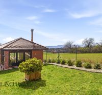 A family house in Kopanice in Krupina with a view of the garden and the surrounding countryside.