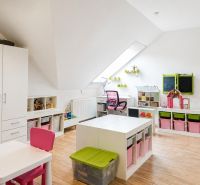 Children's room with storage spaces and toys in a 3-room apartment. Floor with wooden decor.