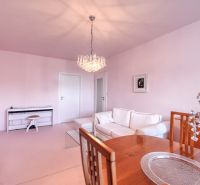 A bright living room with a piano, sofa, and dining table. 4-room apartment.