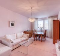 Living room in a 4-room apartment with a comfortable sofa and a glass table.