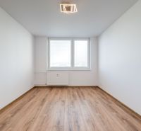 A room with a wooden floor decor in a 3-room apartment without furniture.