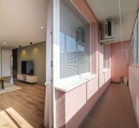 3-room apartment with wood-patterned flooring and a spacious balcony.