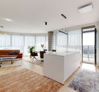 A four-room apartment with wood-patterned flooring, large windows, and a kitchen island.