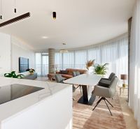 Living room in a 4-room apartment with a dining table and a fireplace, floor with wood decor.