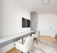 Living room in a 4-room apartment with a television, armchairs, and a wooden decor floor.