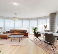 Living room with a sofa, dining table, and wooden decor flooring in a 4-room apartment.