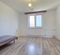 A room in a family house with a bed and a wooden decor floor.