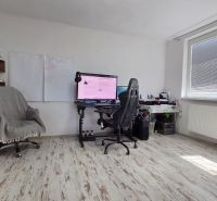 A study in a family house with a computer and a wooden decor floor.