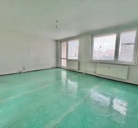 A spacious room in a 3-room apartment with radiators and large windows.