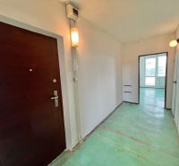 A hallway with an entrance door and a passage to a room in a 3-room apartment.