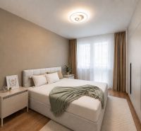 A bright bedroom with a bed, wardrobe, and wooden decor flooring in a 3-room apartment.