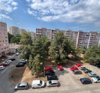 Apartment buildings on Družicová Street in Košice - Nad jazerom district, parking lot, trees.
