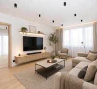 Living room in a three-room apartment with a wooden decor floor and neutral furnishings.