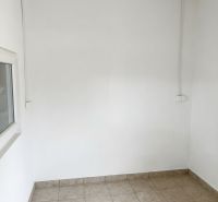 Interior of warehouses and halls with white walls and tiled floors.