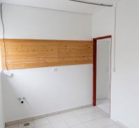 Interior with a wooden paneled wall and tiled floor, suitable for warehouses and halls.